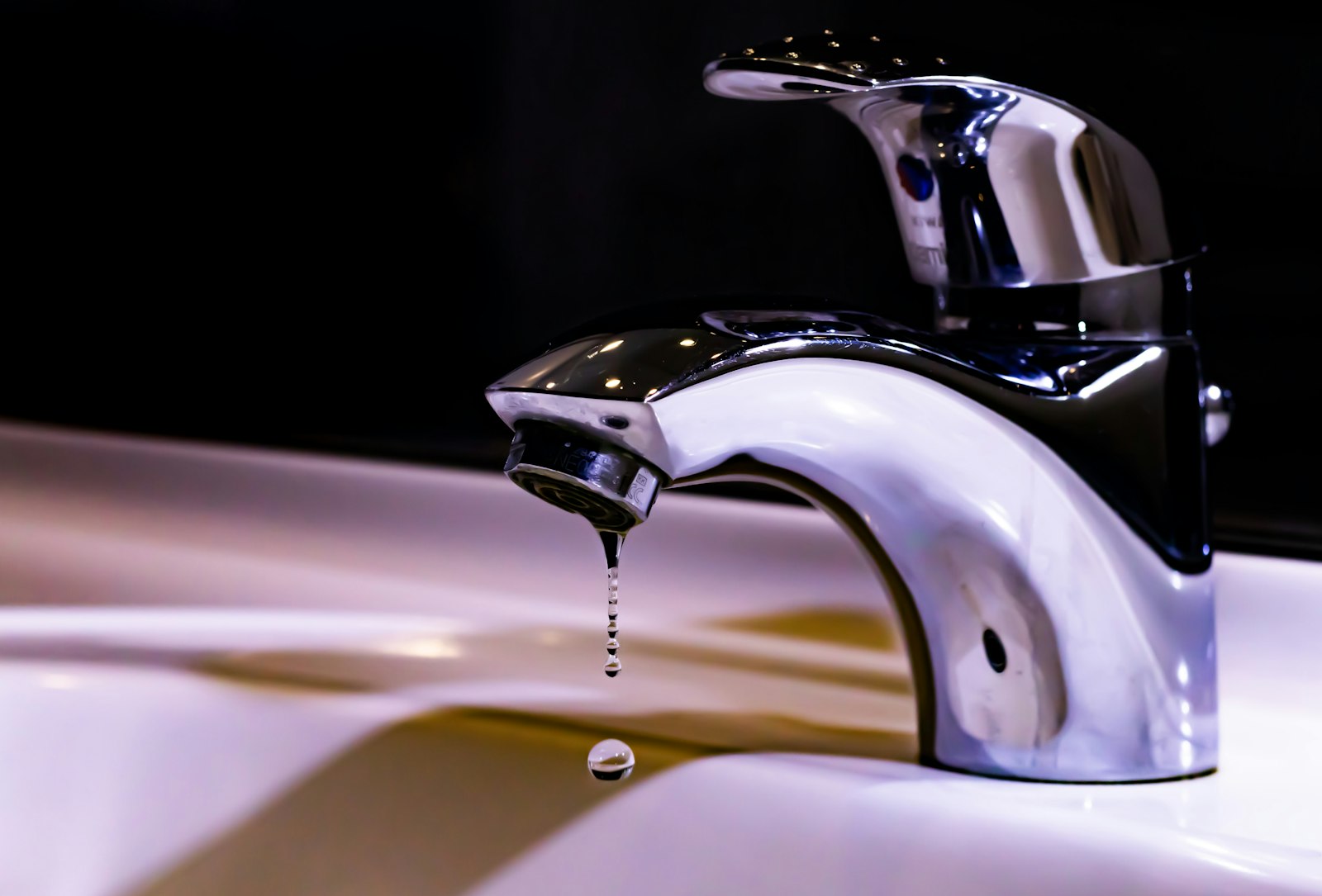Chrome bathroom faucet with a water droplet