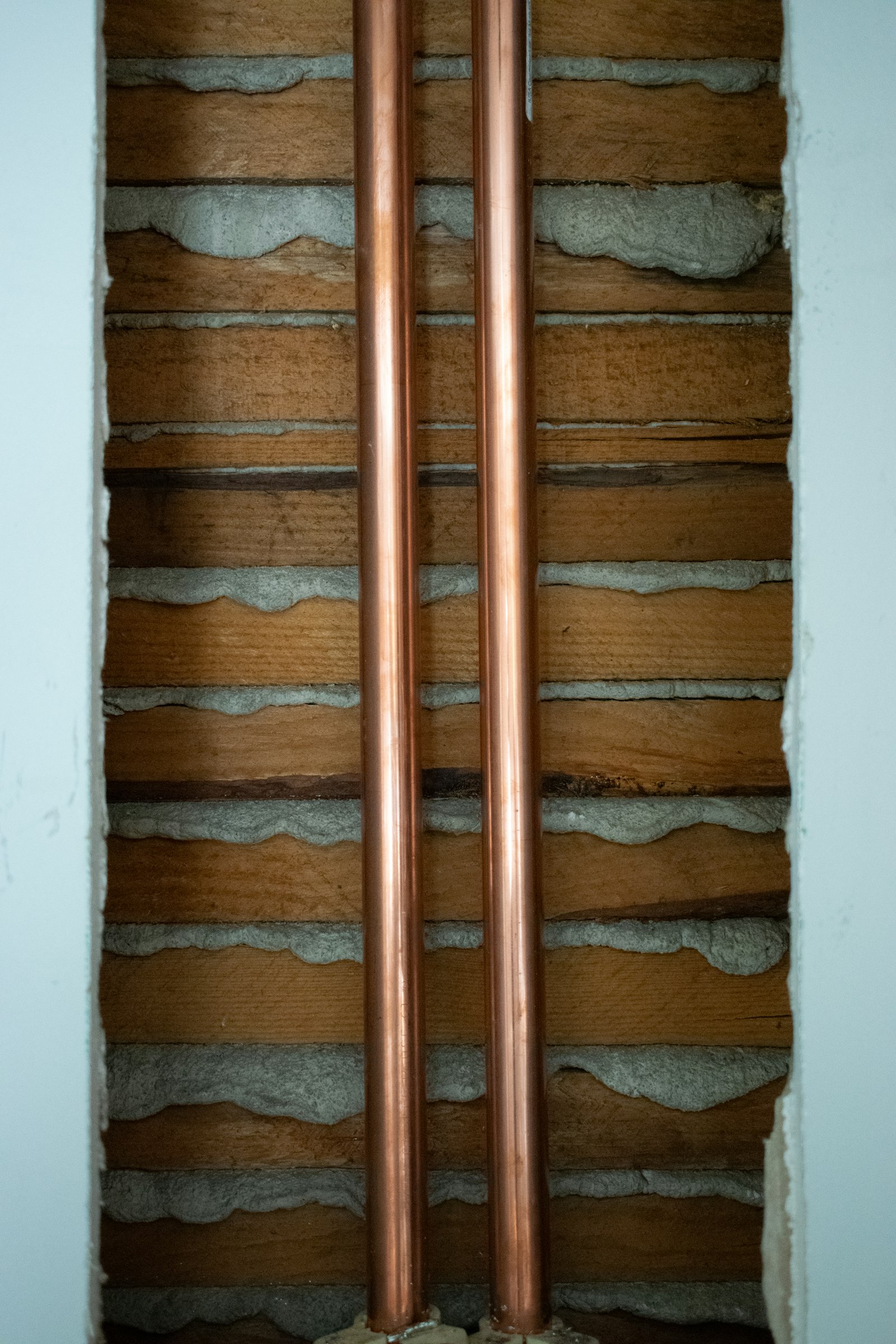 Copper pipe run installed inside a wall cavity