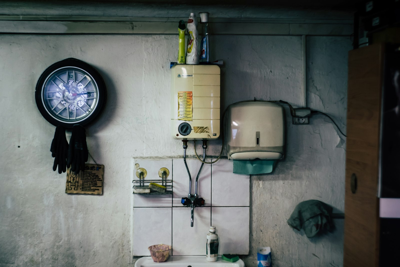 Wall-mounted water heater unit above a sink
